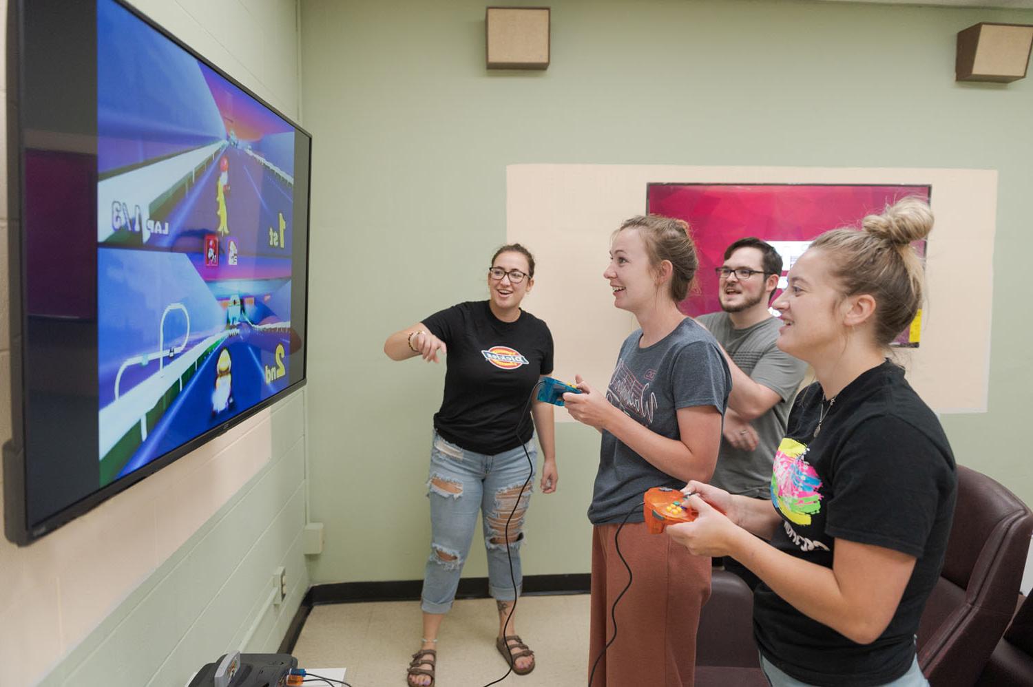 Students play a video game at the King Library