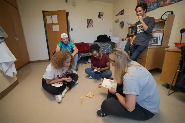 Students play a game in a residence hall